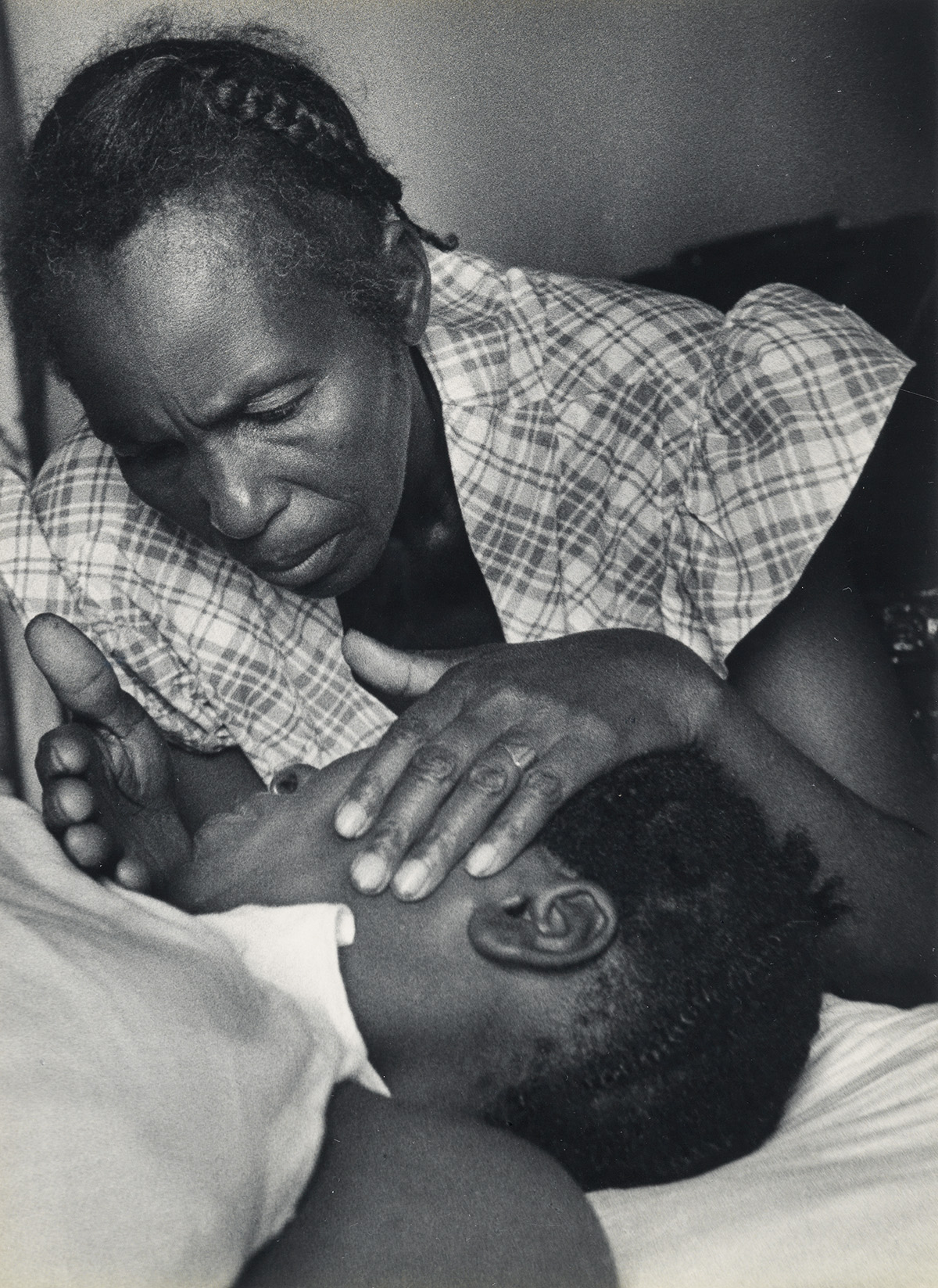 W. EUGENE SMITH (1918-1978) The mothers aunt, Catherine Prileau, trying to soothe her niece, from the Nurse Midwife photo essay in LIF